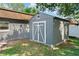 Backyard showing the property's exterior storage shed with double doors and white trim at 12316 Eldon Dr, Largo, FL 33774