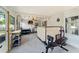 Open sun room featuring a workout area, bar, and dining space, blending fitness and entertainment at 12316 Eldon Dr, Largo, FL 33774
