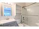 Bathroom featuring tiled shower over tub, a light wood vanity, and shelving to maximize storage space at 1247 Kennewick Ct, Wesley Chapel, FL 33543