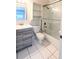 Bathroom featuring tiled shower over tub, a light wood vanity, and shelving to maximize storage space at 1247 Kennewick Ct, Wesley Chapel, FL 33543