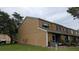 Exterior view of the home featuring a well-maintained yard, multiple windows, and exterior lighting at 1247 Kennewick Ct, Wesley Chapel, FL 33543