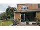Exterior view of the home featuring a screened-in porch and landscaped surroundings at 1247 Kennewick Ct, Wesley Chapel, FL 33543