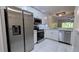 Modern kitchen with stainless steel appliances, white cabinets, and tile backsplash at 1247 Kennewick Ct, Wesley Chapel, FL 33543