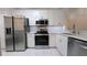 Contemporary kitchen featuring stainless steel appliances, white cabinets, and modern fixtures at 1247 Kennewick Ct, Wesley Chapel, FL 33543