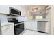 Bright kitchen featuring stainless steel appliances, stylish backsplash and tiled floors at 1247 Kennewick Ct, Wesley Chapel, FL 33543