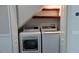 Convenient laundry area with washer, dryer, and built-in shelving for added storage at 1247 Kennewick Ct, Wesley Chapel, FL 33543