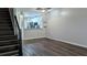 Open-concept living room features hardwood floors and a view into the kitchen, creating a spacious and inviting atmosphere at 1247 Kennewick Ct, Wesley Chapel, FL 33543