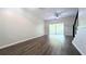 Open living room featuring hardwood floors, a ceiling fan, and a sliding glass door to the outside at 1247 Kennewick Ct, Wesley Chapel, FL 33543
