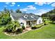 Aerial view of a charming home with well-maintained landscaping, lush greenery, and a spacious yard at 13321 Lewis Raulerson Rd, Dover, FL 33527