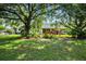 Lush backyard view showcases mature trees and landscaping creating a private and serene outdoor space at 13321 Lewis Raulerson Rd, Dover, FL 33527