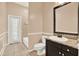 Well-lit bathroom featuring a vanity with granite countertop, toilet, and shower with tiled walls at 13321 Lewis Raulerson Rd, Dover, FL 33527
