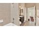Bathroom featuring tiled shower, granite vanity, and adjacent tile flooring at 13321 Lewis Raulerson Rd, Dover, FL 33527