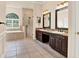 Bright bathroom showcasing a dual sink vanity, a soaking tub, and a glass-enclosed shower at 13321 Lewis Raulerson Rd, Dover, FL 33527