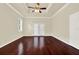 Spacious bedroom featuring rich hardwood floors and a ceiling fan at 13321 Lewis Raulerson Rd, Dover, FL 33527