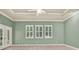Bright bedroom featuring tile floors, shutters, and a trey ceiling with a ceiling fan at 13321 Lewis Raulerson Rd, Dover, FL 33527