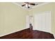 Bedroom featuring hardwood floors, a ceiling fan, and a closet, offering a cozy retreat at 13321 Lewis Raulerson Rd, Dover, FL 33527