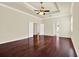 Expansive bedroom with gleaming floors, trey ceiling, and convenient access to the en-suite bathroom at 13321 Lewis Raulerson Rd, Dover, FL 33527