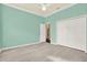Cozy bedroom with sleek floors, light blue walls, and ample closet space at 13321 Lewis Raulerson Rd, Dover, FL 33527