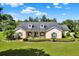 Charming one-story home boasting a well-manicured lawn, green shutters, and a welcoming front porch at 13321 Lewis Raulerson Rd, Dover, FL 33527