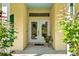 Inviting front entrance featuring decorative glass doors and manicured landscaping at 13321 Lewis Raulerson Rd, Dover, FL 33527