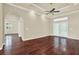 Open-concept living room featuring hardwood floors, tray ceiling, and access to other rooms at 13321 Lewis Raulerson Rd, Dover, FL 33527