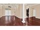 Inviting living room with hardwood floors and an open layout, leading to the kitchen at 13321 Lewis Raulerson Rd, Dover, FL 33527