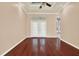 Spacious living room with hardwood floors, tray ceiling, and natural light from french doors at 13321 Lewis Raulerson Rd, Dover, FL 33527