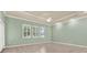 Bright, spacious living room with tile floors, neutral paint, and ample natural light at 13321 Lewis Raulerson Rd, Dover, FL 33527