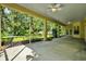 Spacious screened-in patio with ceiling fans and lush landscaping views, perfect for outdoor entertaining at 13321 Lewis Raulerson Rd, Dover, FL 33527