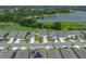 Aerial view of the home in a lakeside community with lush green surroundings, showcasing its desirable neighborhood location at 13735 Wineberry Dr, Dade City, FL 33525