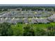 Aerial view of the home with a large backyard and partial fence, showing its location in a residential neighborhood at 13735 Wineberry Dr, Dade City, FL 33525