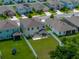 Aerial view of backyard featuring a covered patio with seating and a white fence at 13735 Wineberry Dr, Dade City, FL 33525