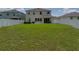 Large backyard with a covered patio and ample green space at 13735 Wineberry Dr, Dade City, FL 33525