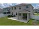Backyard featuring a covered patio with seating, barbecue, and lawn at 13735 Wineberry Dr, Dade City, FL 33525