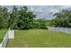 Fenced-in backyard with trees and lake view at 13735 Wineberry Dr, Dade City, FL 33525