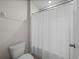 A clean bathroom is shown with a white shower curtain at 13735 Wineberry Dr, Dade City, FL 33525