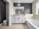 Bathroom featuring granite vanity, soaking tub and toilet at 13735 Wineberry Dr, Dade City, FL 33525