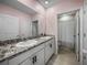 This bathroom features double sinks and granite countertops at 13735 Wineberry Dr, Dade City, FL 33525