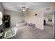 This bedroom has neutral carpet, ceiling fan and an open doorway to another room at 13735 Wineberry Dr, Dade City, FL 33525