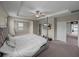 Spacious primary bedroom with carpet, trey ceilings, and ensuite bath and closet access at 13735 Wineberry Dr, Dade City, FL 33525