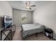 Neutral bedroom featuring a comfortable bed and a window bringing in natural light at 13735 Wineberry Dr, Dade City, FL 33525