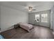 This bedroom features a ceiling fan and two windows at 13735 Wineberry Dr, Dade City, FL 33525