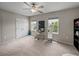 This bedroom has neutral carpet, ceiling fan and two windows at 13735 Wineberry Dr, Dade City, FL 33525