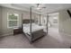 Spacious bedroom with trey ceilings, neutral paint, carpet, and natural light at 13735 Wineberry Dr, Dade City, FL 33525