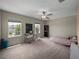 This bedroom has neutral carpet, ceiling fan and two windows at 13735 Wineberry Dr, Dade City, FL 33525