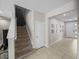 Bright entryway with tiled floors leading to carpeted stairs and the front door at 13735 Wineberry Dr, Dade City, FL 33525