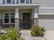 Close-up of the home's entrance, highlighting the stone-clad columns and manicured landscaping, with neutral gray color at 13735 Wineberry Dr, Dade City, FL 33525