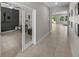 Hallway view showcasing open access to an office and the living room at 13735 Wineberry Dr, Dade City, FL 33525
