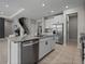Modern kitchen features white cabinets, stainless steel appliances, granite countertops, and a large island with a sink at 13735 Wineberry Dr, Dade City, FL 33525