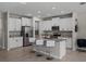 Bright kitchen features white cabinets, granite countertops, stainless steel appliances, and a large island with barstool seating at 13735 Wineberry Dr, Dade City, FL 33525